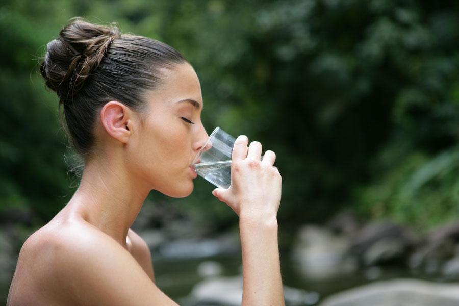 a young woman drinking water